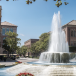 Image of fountain from Hahn Plaza in foreground with the Student Union and Bovard buildings in the backgound.